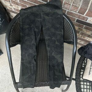 Green leggings with a black flower pattern